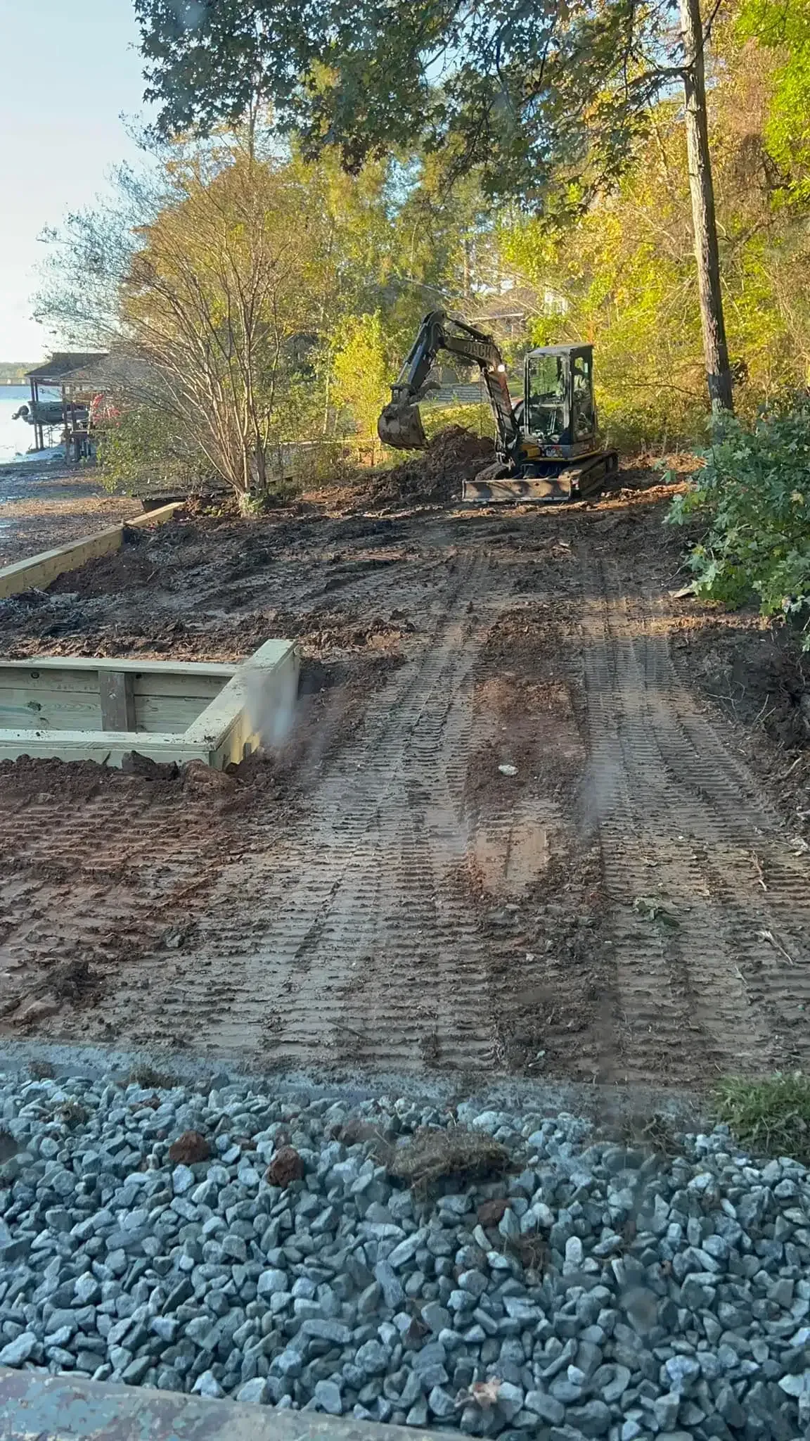 Excavator grading and clearing land for a functional outdoor space in Columbus, GA