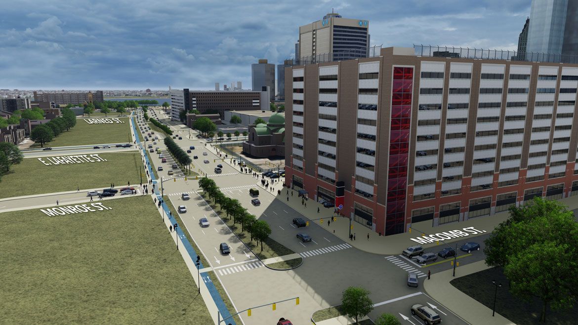 An aerial view of a city street with a large building in the background.
