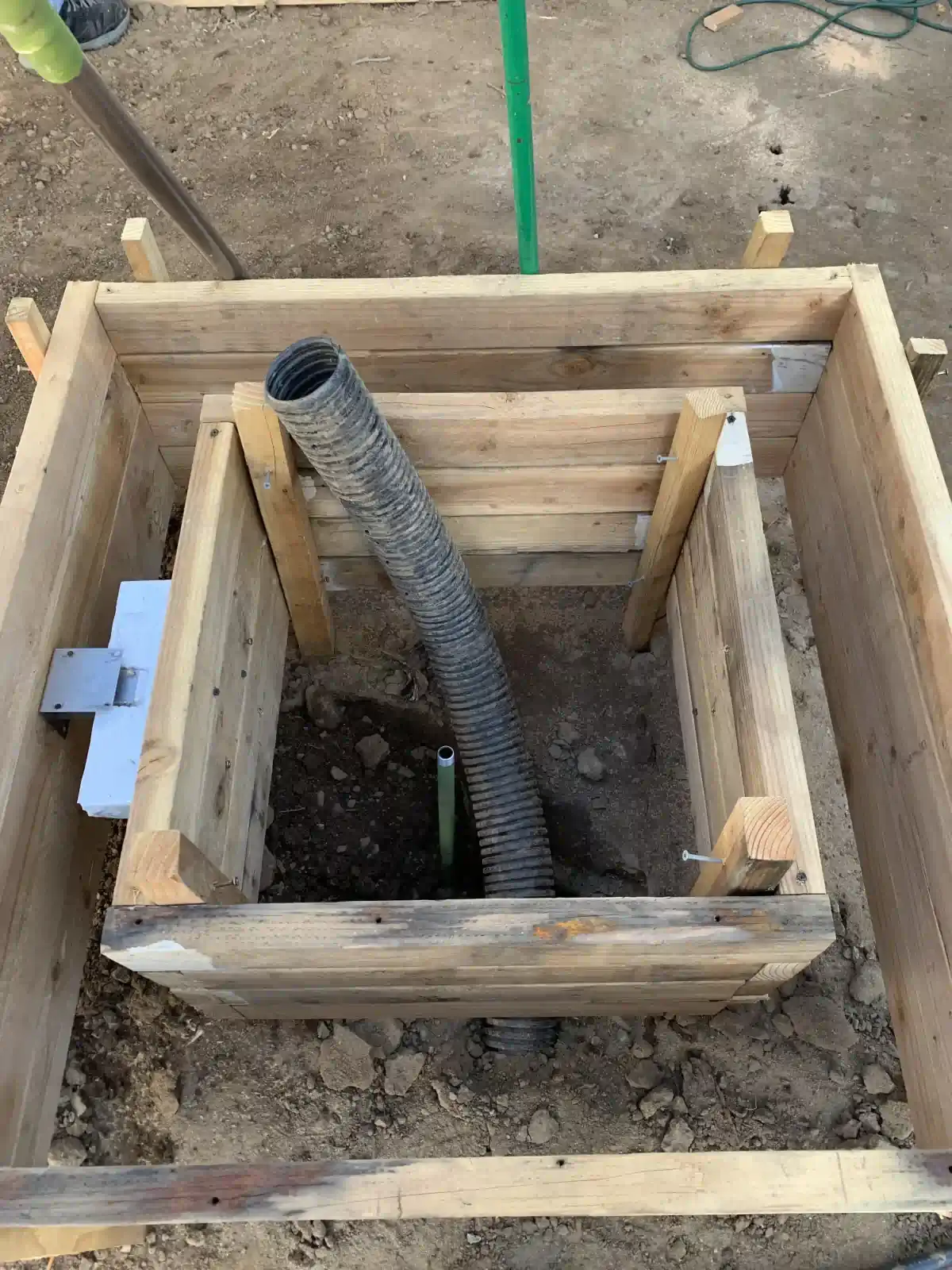 A wooden box with a hose coming out of it.