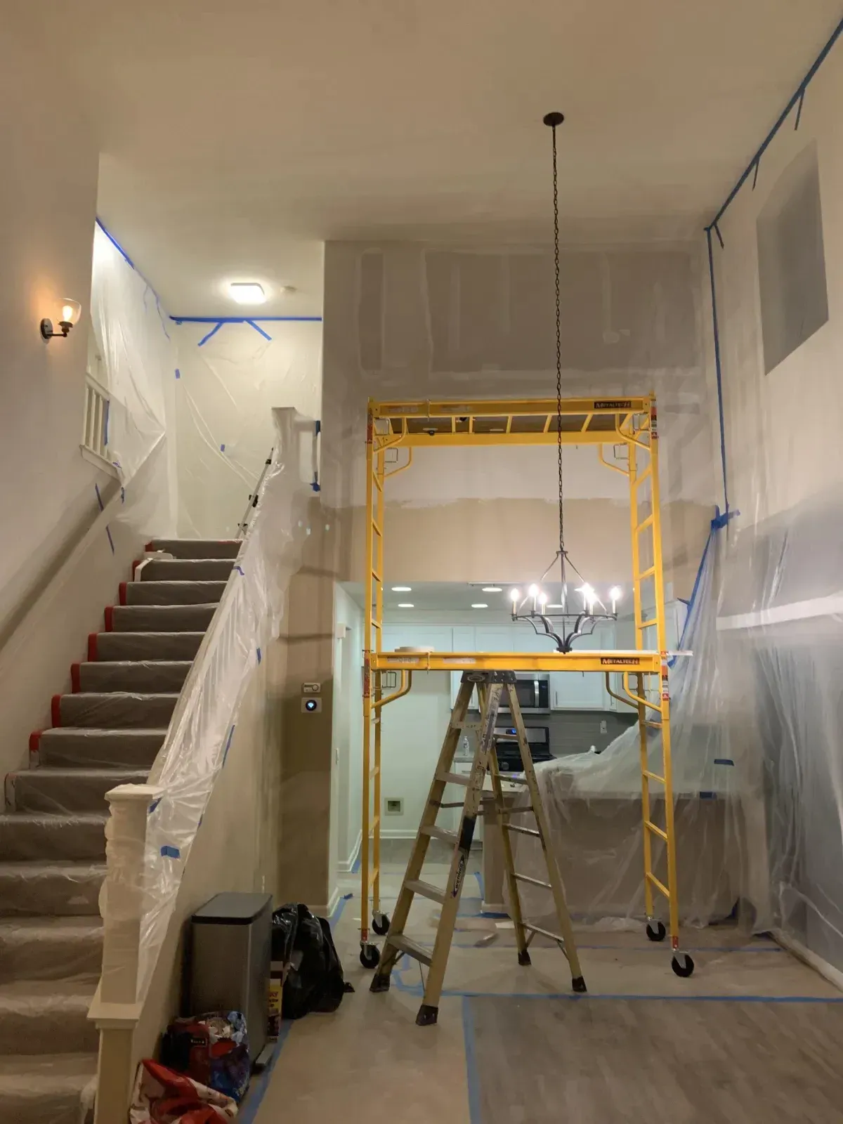 A room with stairs and a yellow scaffolding in it.