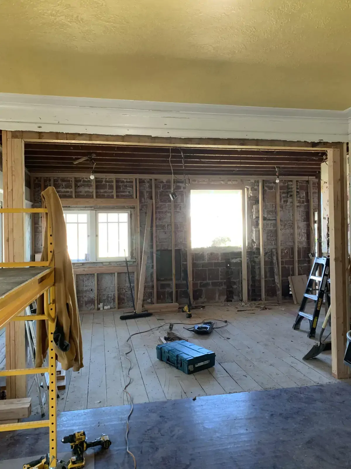 A room that is being remodeled with a lot of tools on the floor.