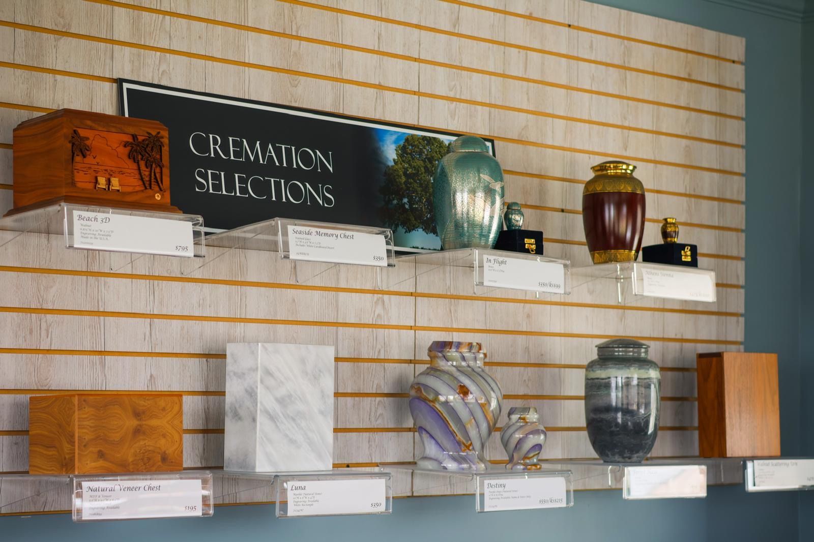 Cremation urns displayed on shelves in a funeral home selection area