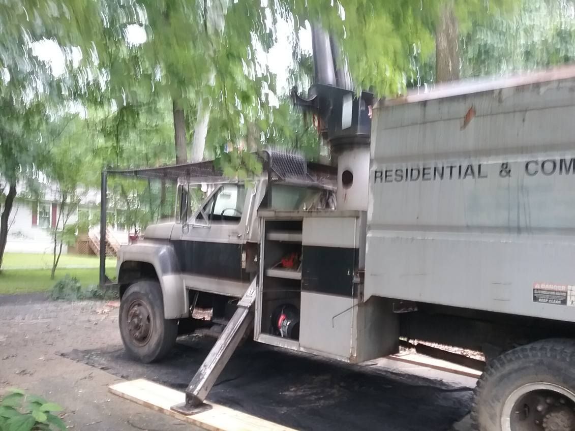A residential and commercial truck is parked in a driveway