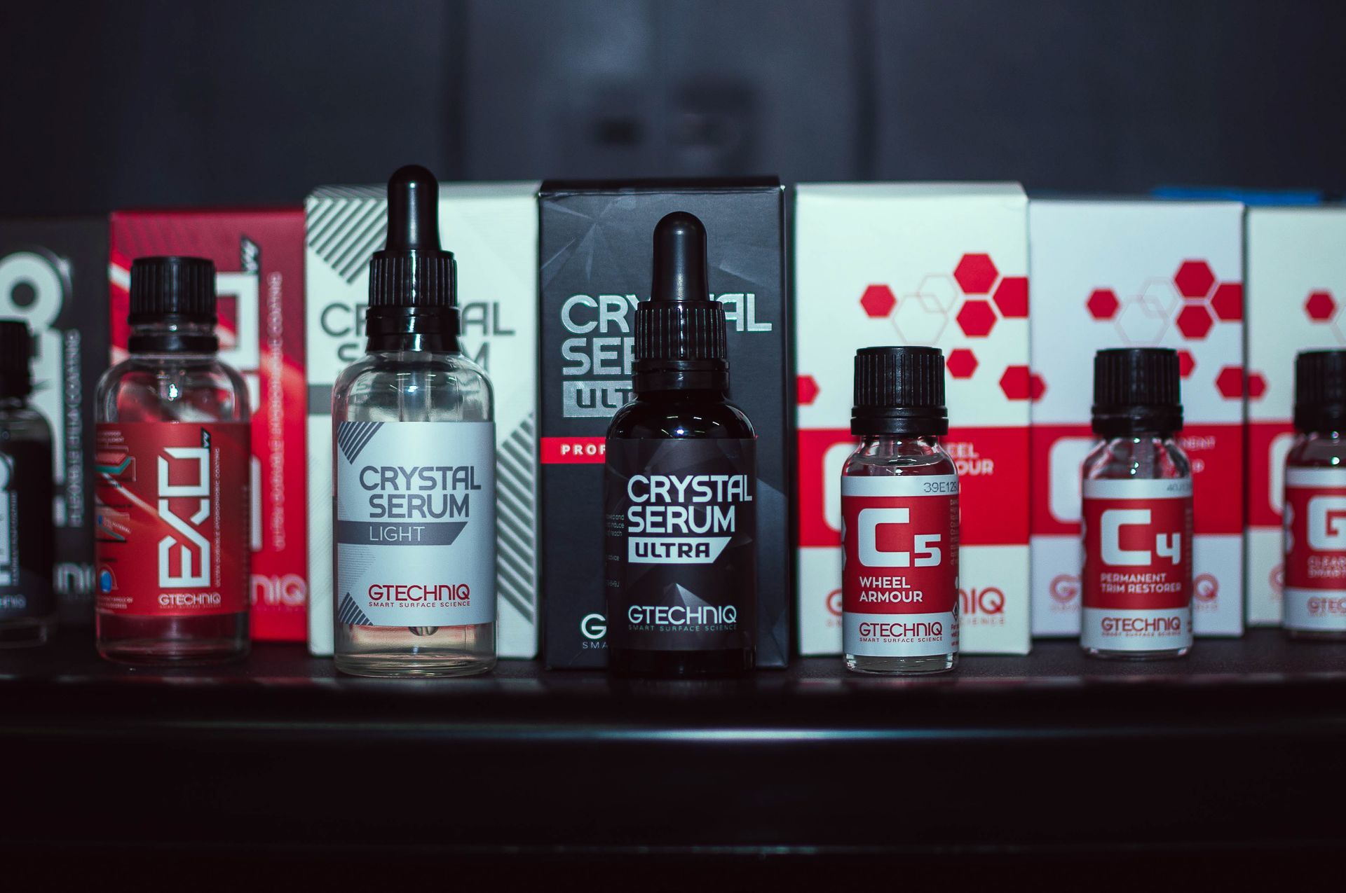 Row of red and silver C4 Crystal Serum bottles displayed on a shelf