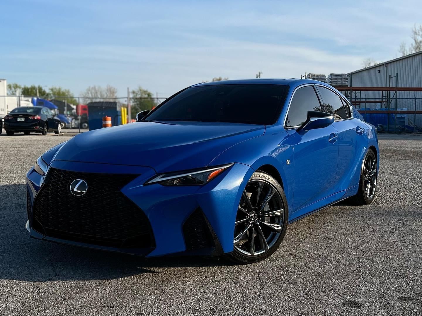 Blue Lexus sports sedan parked outdoors on a sunny day
