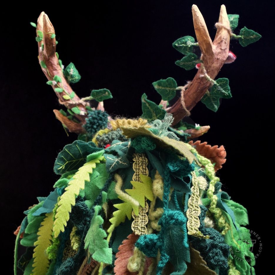 The back of the skeleton puppet showing the handmade detailed leaves made from green felt, wool and fabrics. 