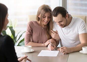 Couple Clients Signing A Documents — Home Loan Types in Slade Point QLD