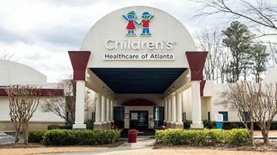 Children's Healthcare of Atlanta building entrance with archway, logo, and outdoor landscaping.