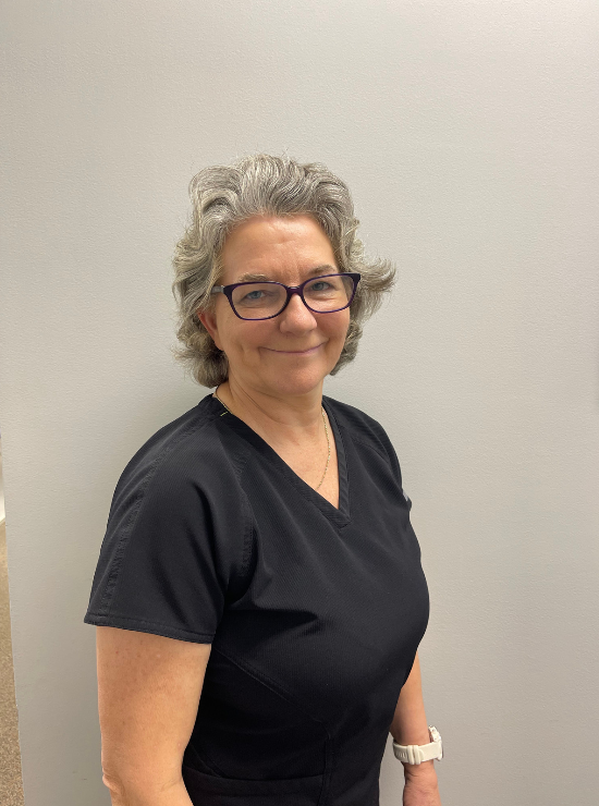 Meet our friendly dental staff in NC | Dr. Walker A woman wearing glasses and a black shirt is smiling for the camera.