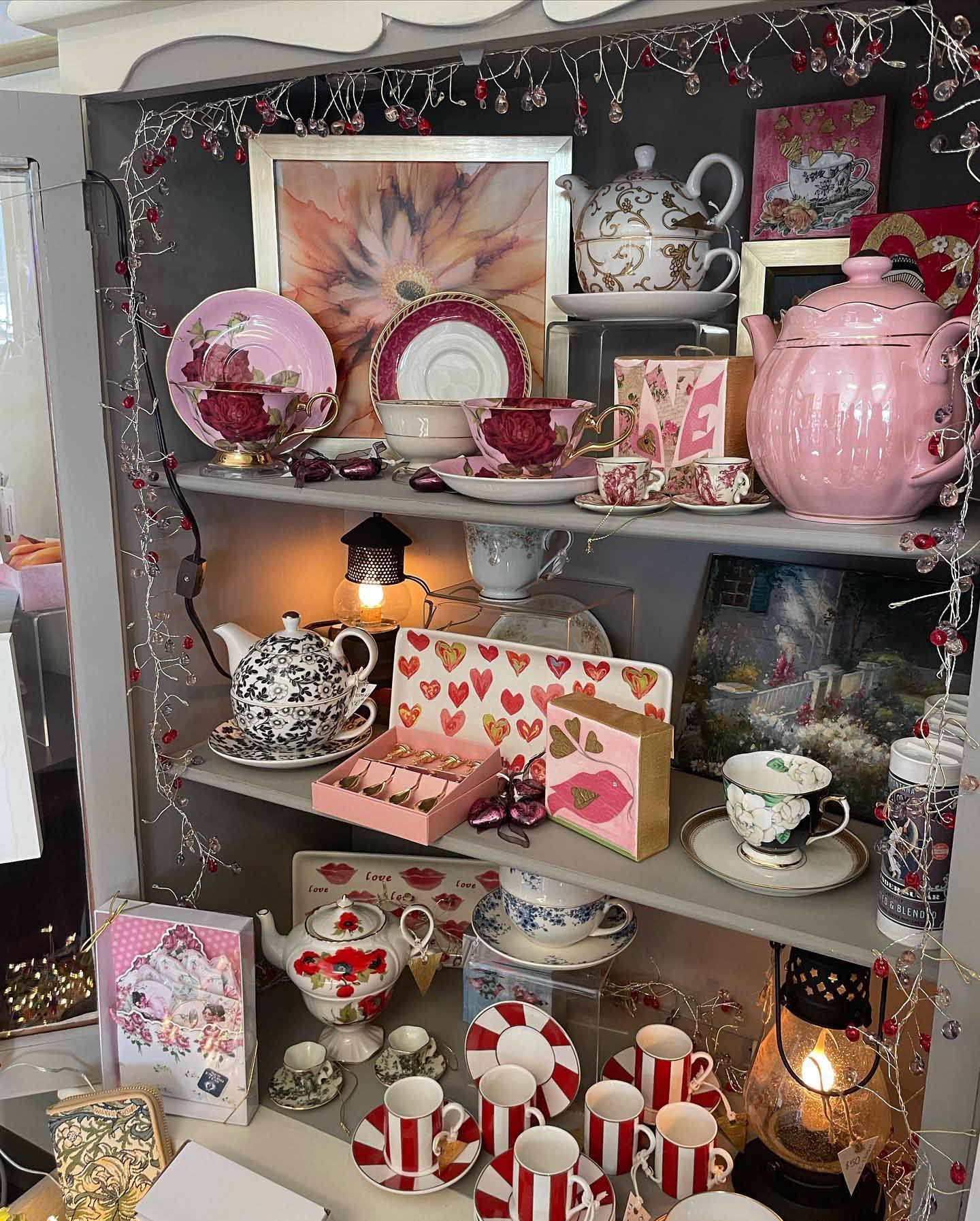 A shelf filled with lots of tea cups and saucers