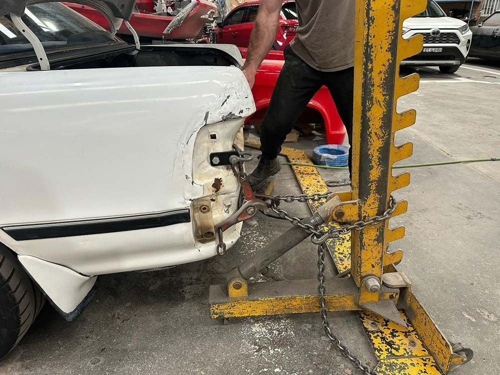 Chaining Back of a Car for Repair — John Zelukovic Smash Repairs in Dubbo, NSW