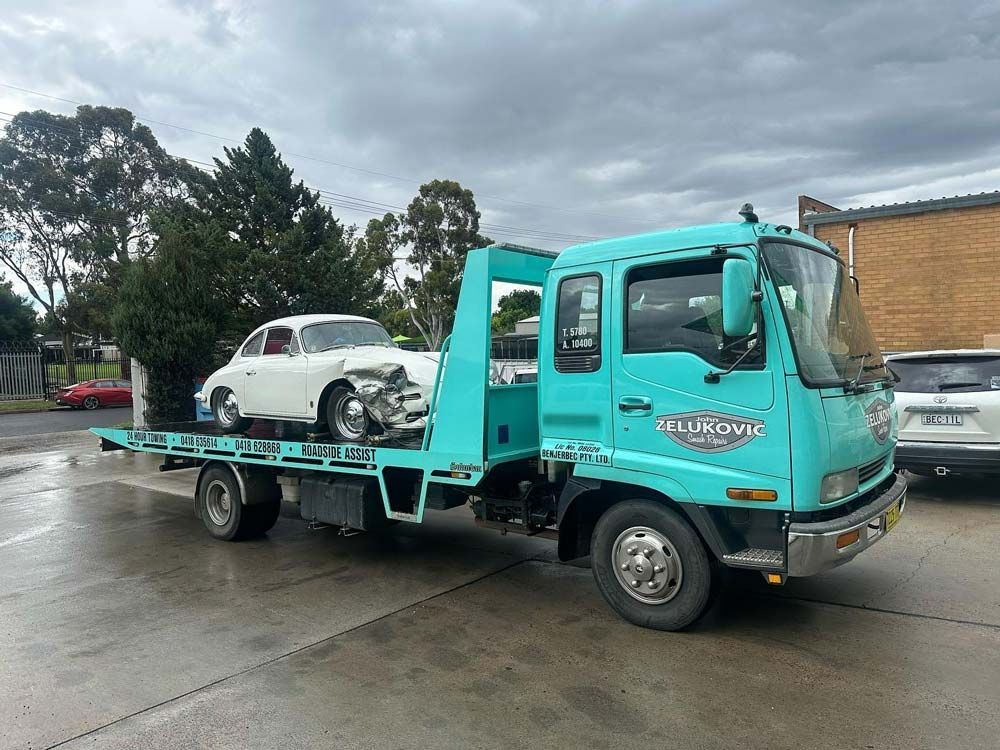 Beetle Car Towed for Repair — John Zelukovic Smash Repairs in Lithgow, NSW