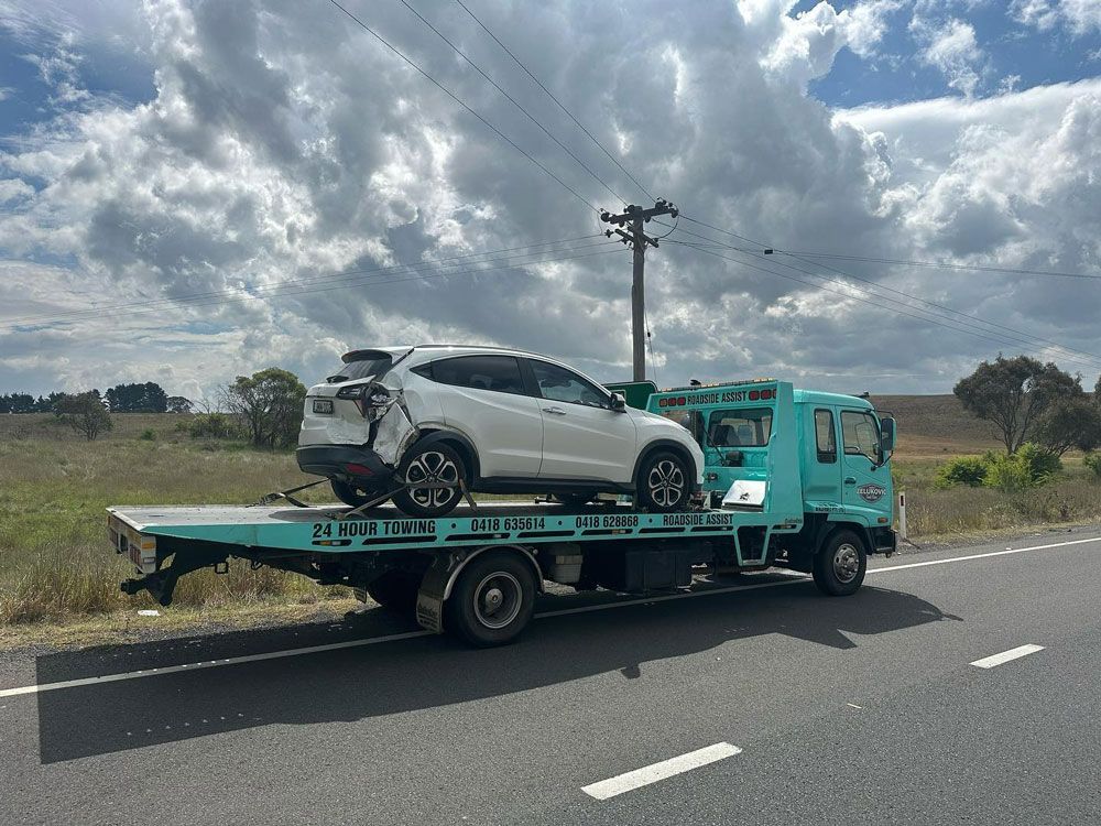 Wrecked Car Loaded on a Towing Truck — John Zelukovic Smash Repairs in Bathurst, NSW