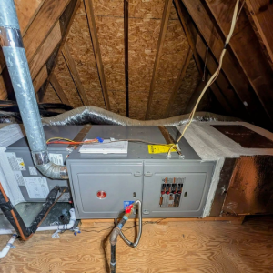 Attic HVAC furnace with ducts, metal vent pipe, and exposed insulation and rafters.
