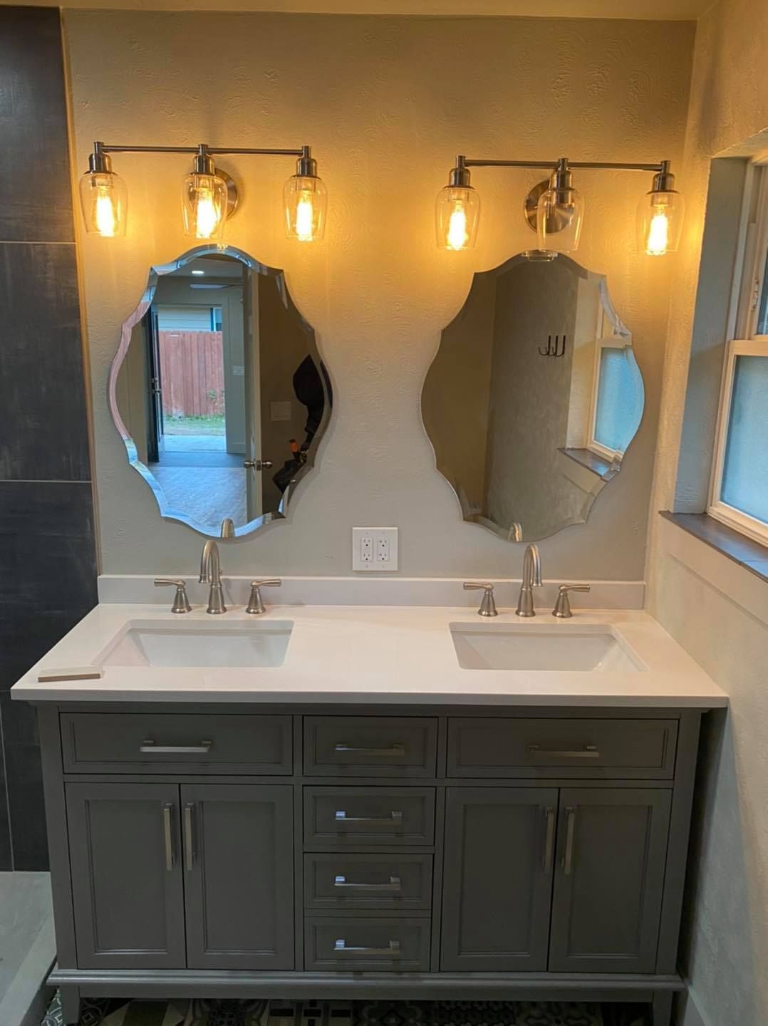 A bathroom with two sinks and two mirrors.