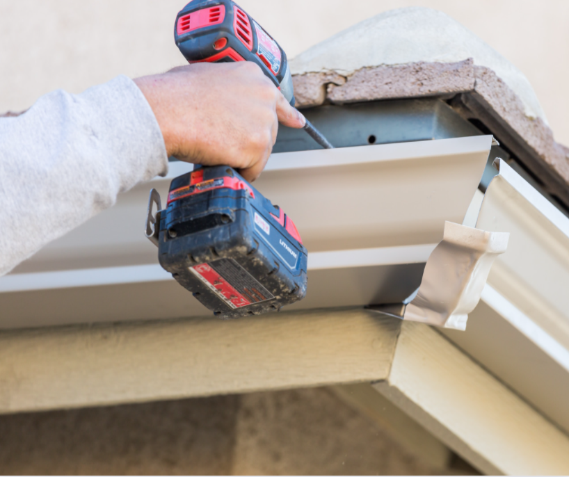 roofing contractor installing gutters