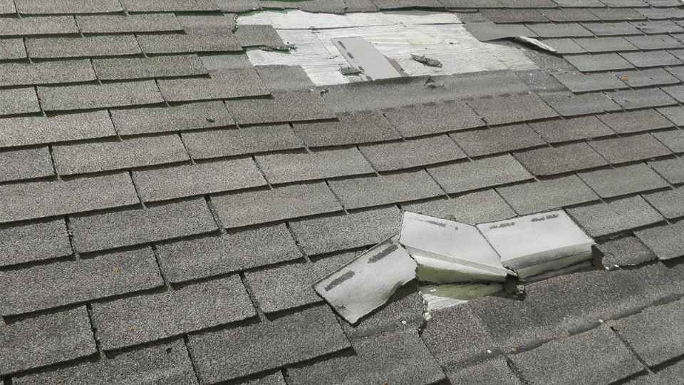 roofing contractor repairing roof
