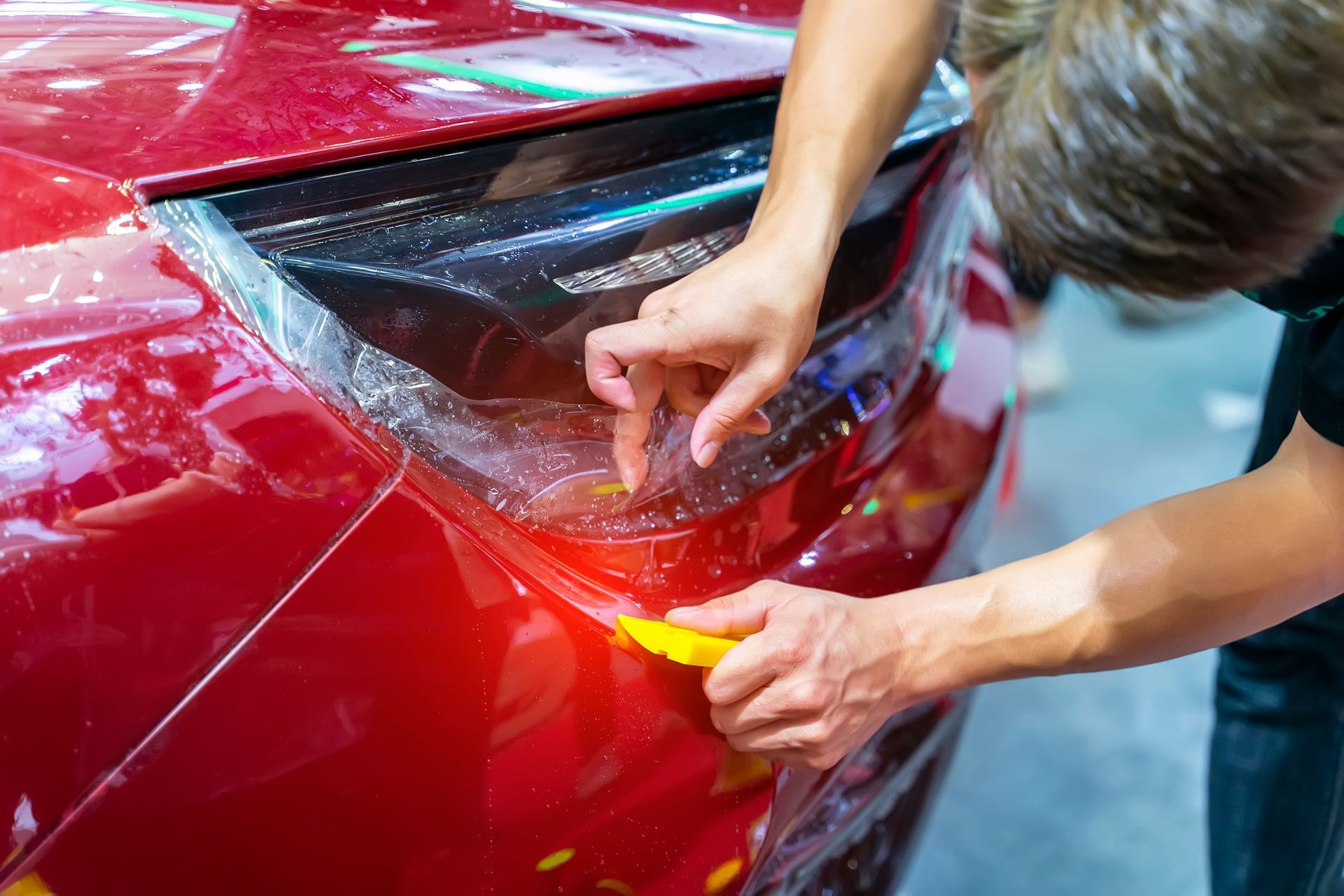 Worker Install Car Paint Protection Film — Metairie, LA — Sundown Tint & Auto Protection