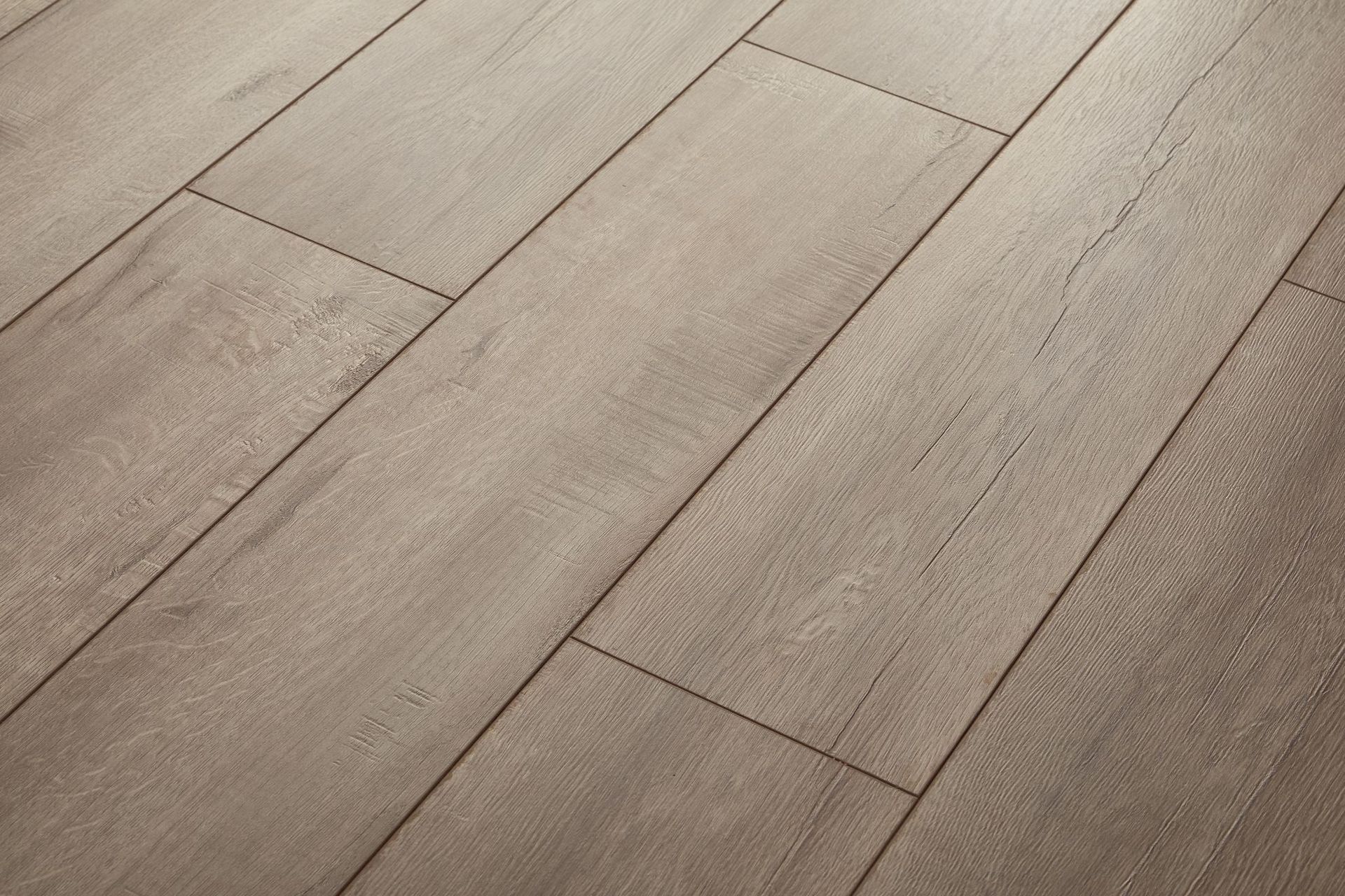 Diagonal view of light wood plank flooring with subtle grain and seams