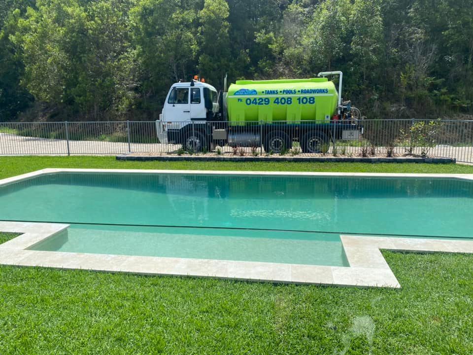 A Completed Swimming Pool Fill With Water Truck In The Background— Jaiden Tanners Water Supplies in Murwillumbah, NSW