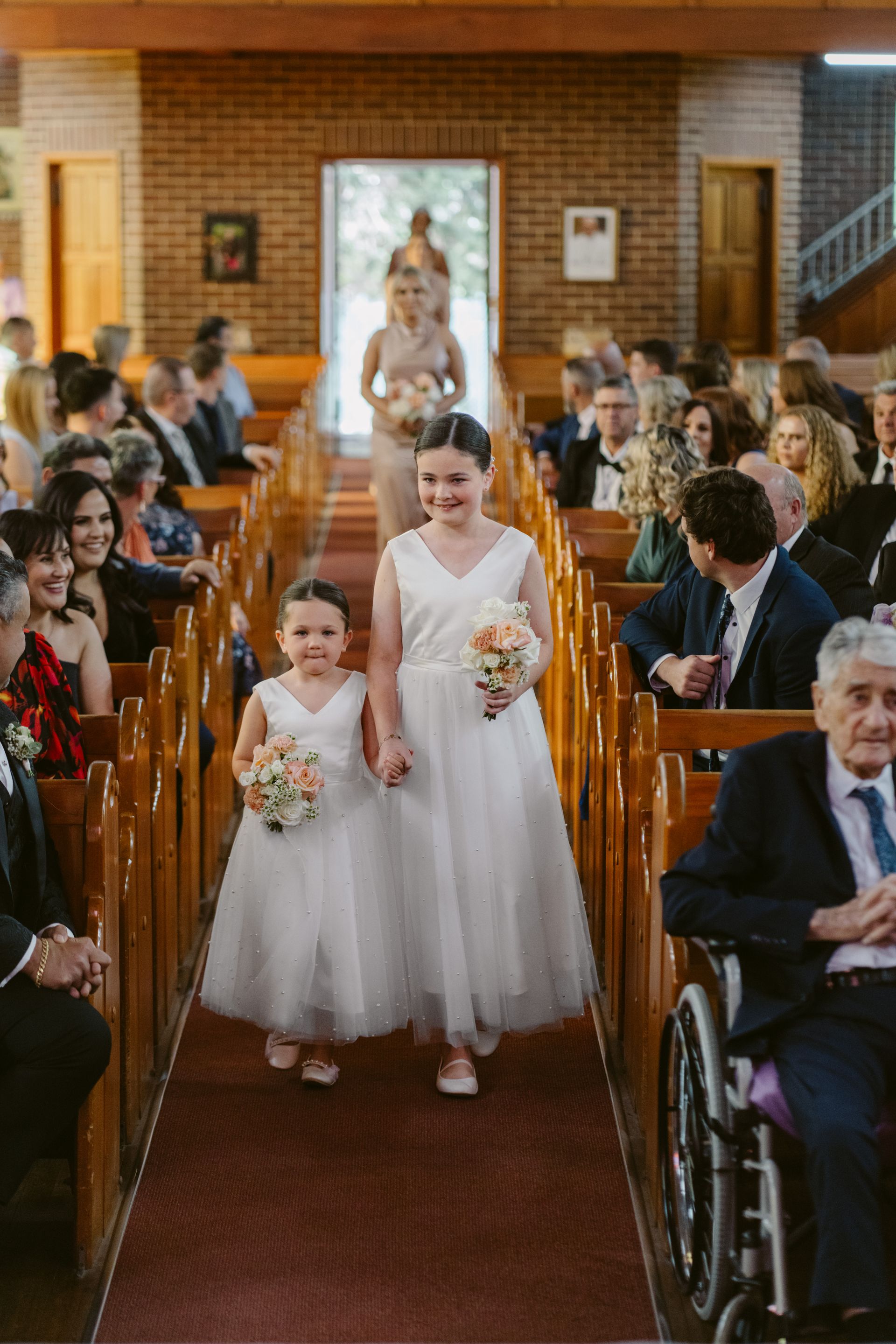 Bride and flower girl walking down the aisle in a church ceremony