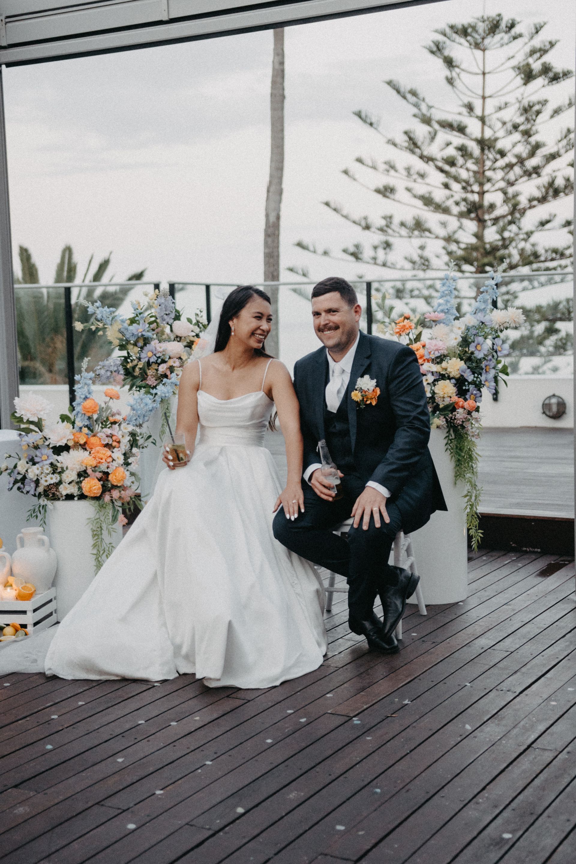 Bride and groom seated together in a decorated outdoor wedding venue
