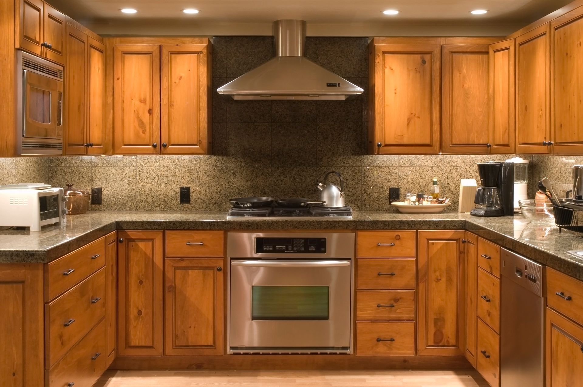 A kitchen with wooden cabinets and stainless steel appliances