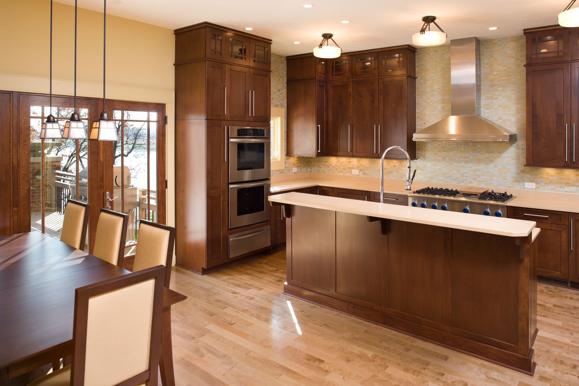 A kitchen with stainless steel appliances and wooden cabinets
