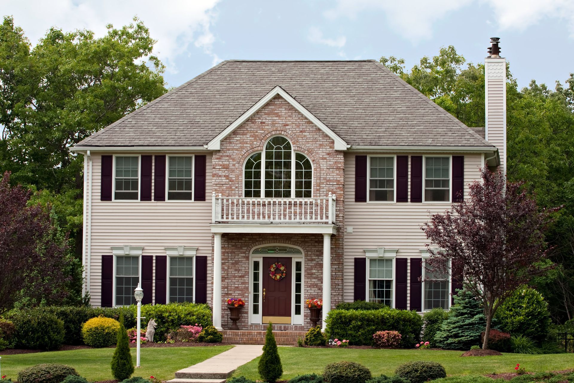 A large house with a lot of windows and shutters