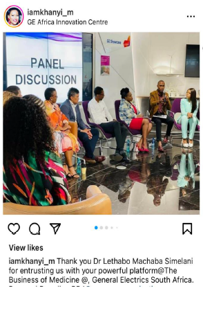 Panel discussion at GE Africa Innovation Centre. People sitting, discussing. Woman in colorful dress.