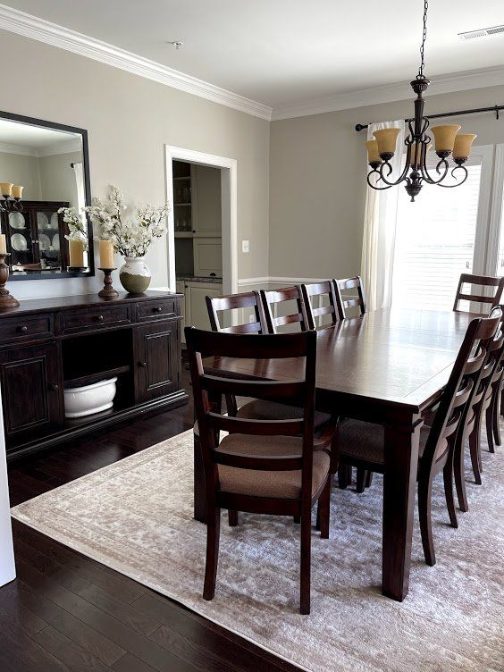 A dining room with a long table and chairs