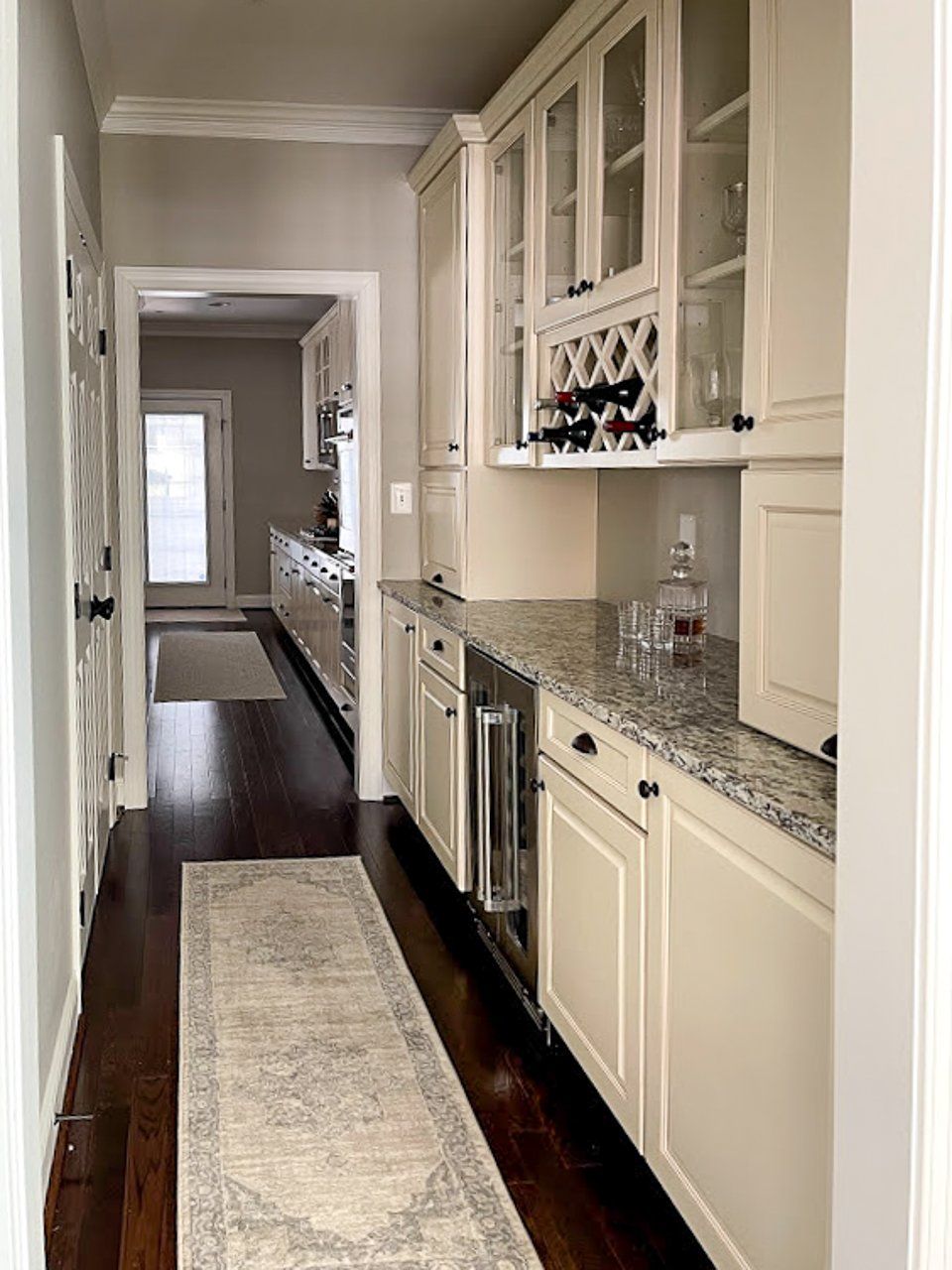 A kitchen with white cabinets and granite counter tops