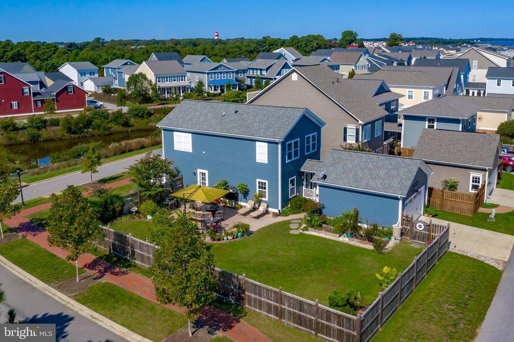 An aerial view of a blue house in a residential area