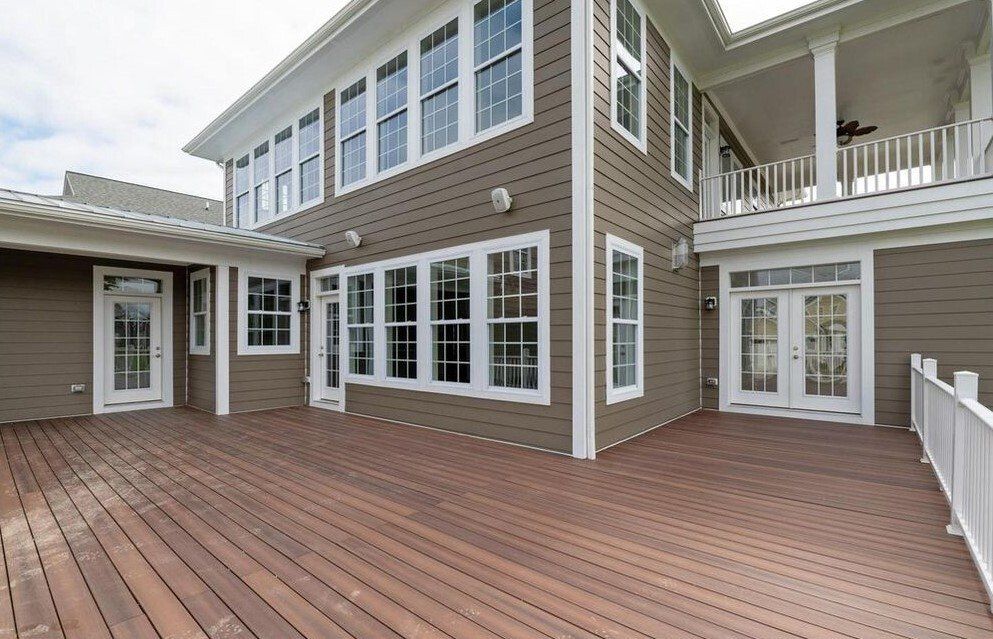 Exterior of the back of a two story brown home with a reddish brown deck | Build on Your Lot | Covell Communities | Chester, Maryland 21619