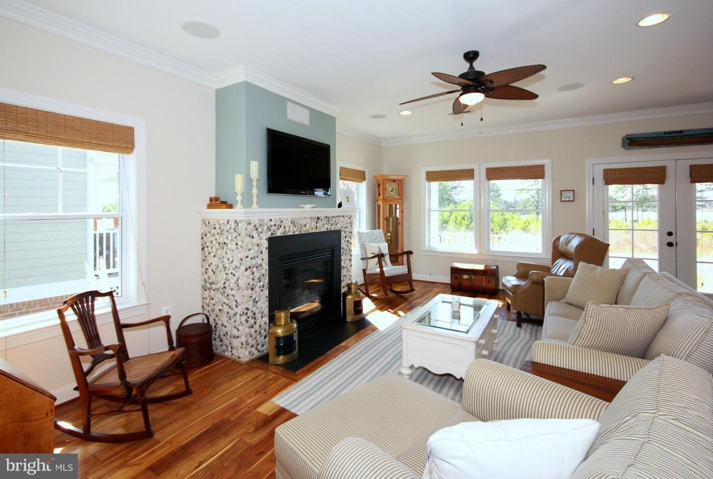A living room with a fireplace and a flat screen tv