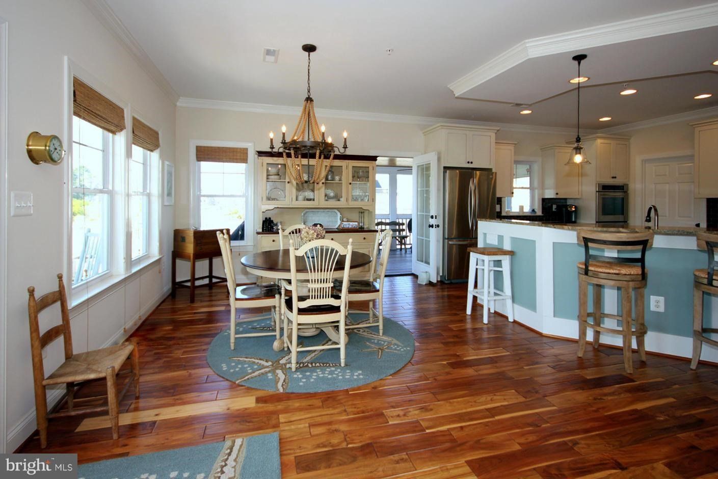 There is a dining room table and chairs in the middle of the room.