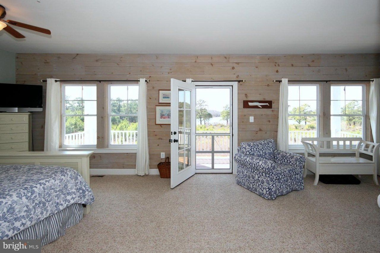 A bedroom with a bed , chair and television