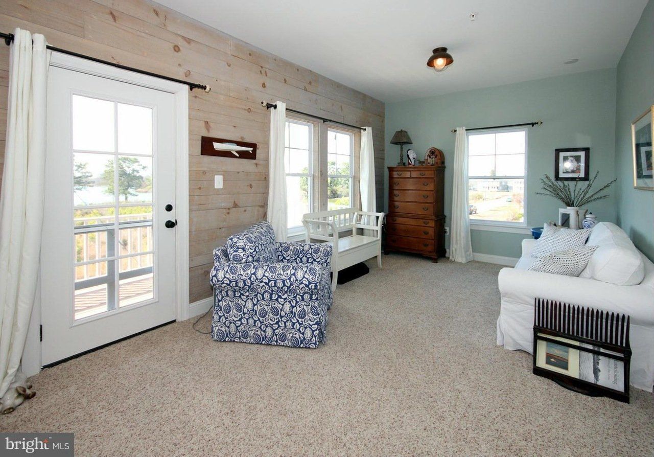 A living room with a couch , chair and dresser