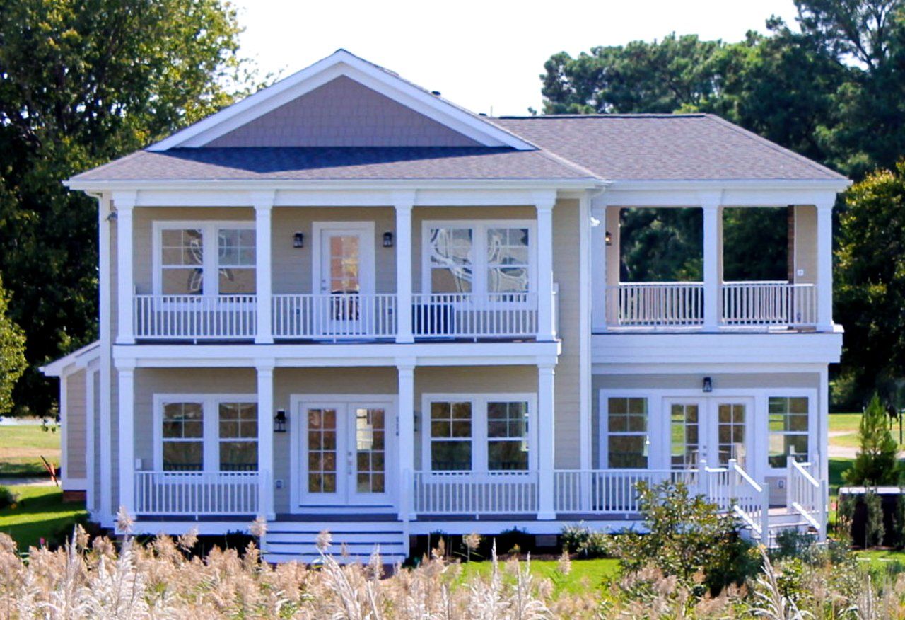 A large house with a lot of windows and porches