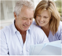 Smiling couple looking at documents | Covell Communities | Chester, Maryland 21619