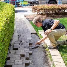 Man Installing Paver In Driveway — Jacksonville FL — Paver Protections LLC