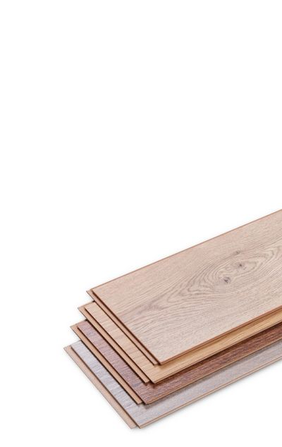 A stack of wooden flooring boards of different colors on a white background.