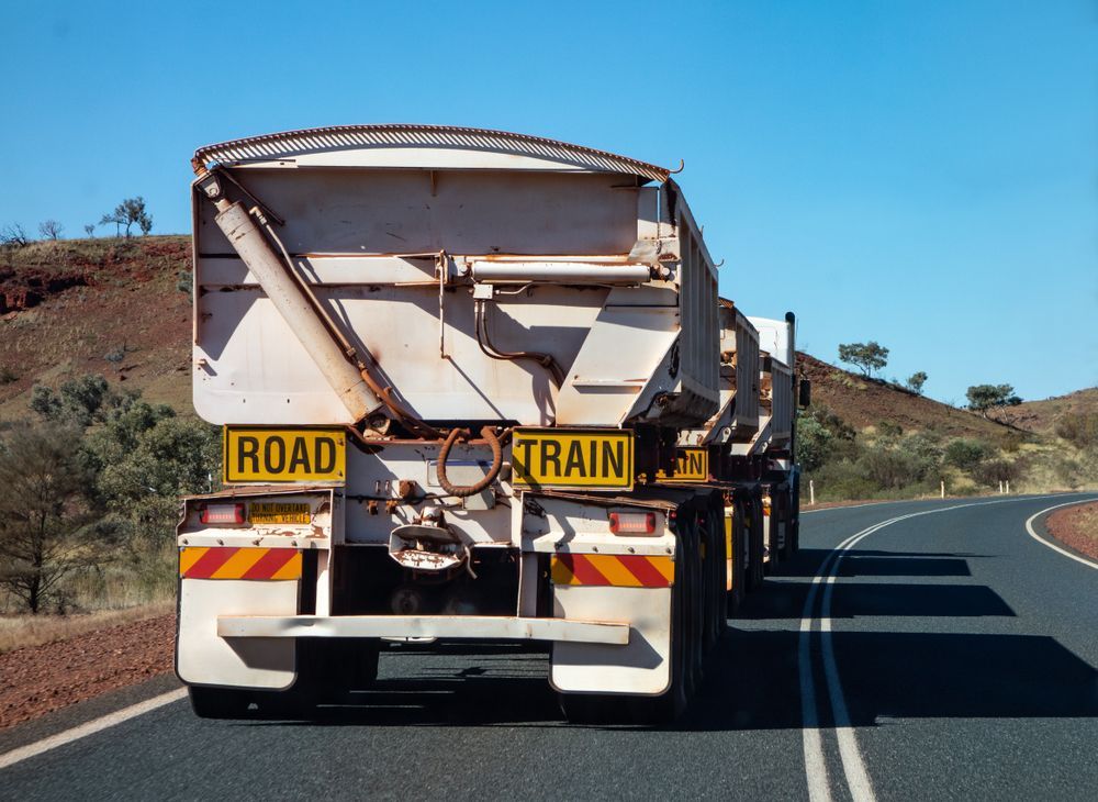Rear View of a White Road Train Hauling Cargo — Mission Truck Training in Mountain Creek, QLD