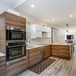 A kitchen with wooden cabinets and stainless steel appliances