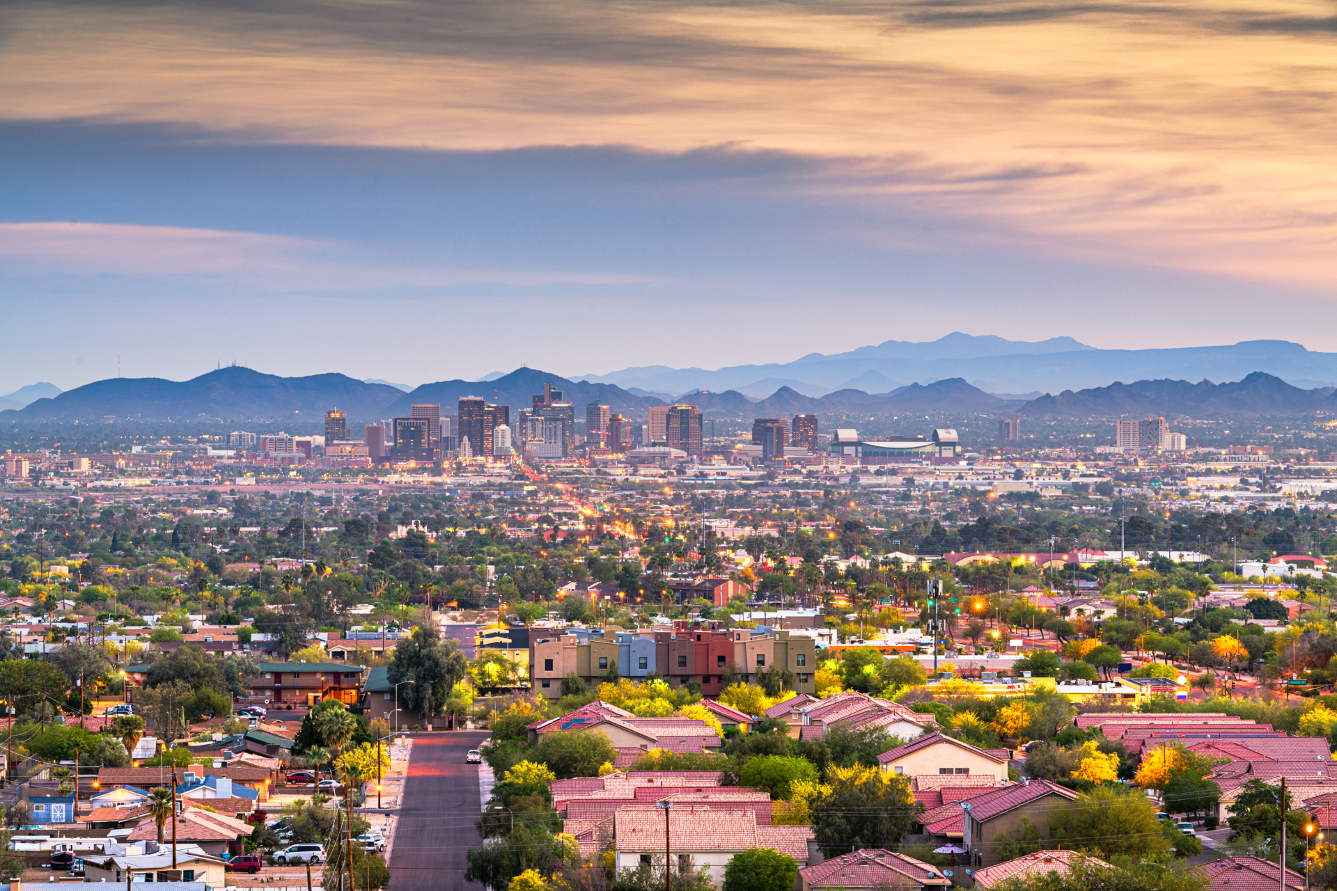 An aerial view of a city with mountains in the background.
