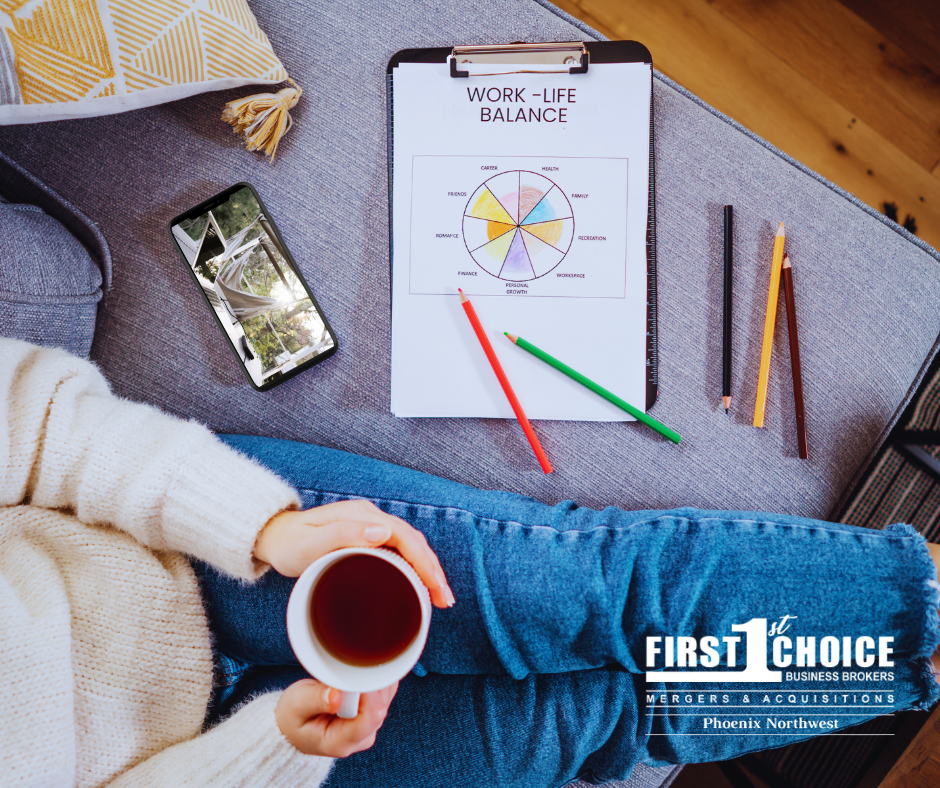 A woman is sitting on a couch holding a cup of coffee.