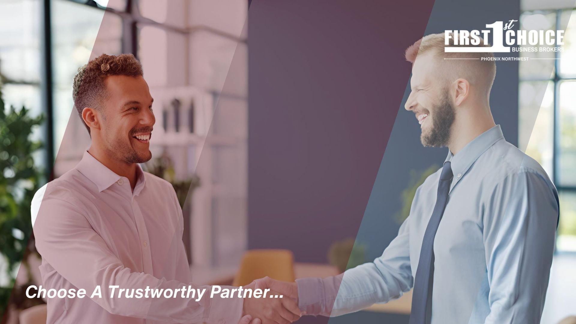 Two men are shaking hands in an office and smiling.