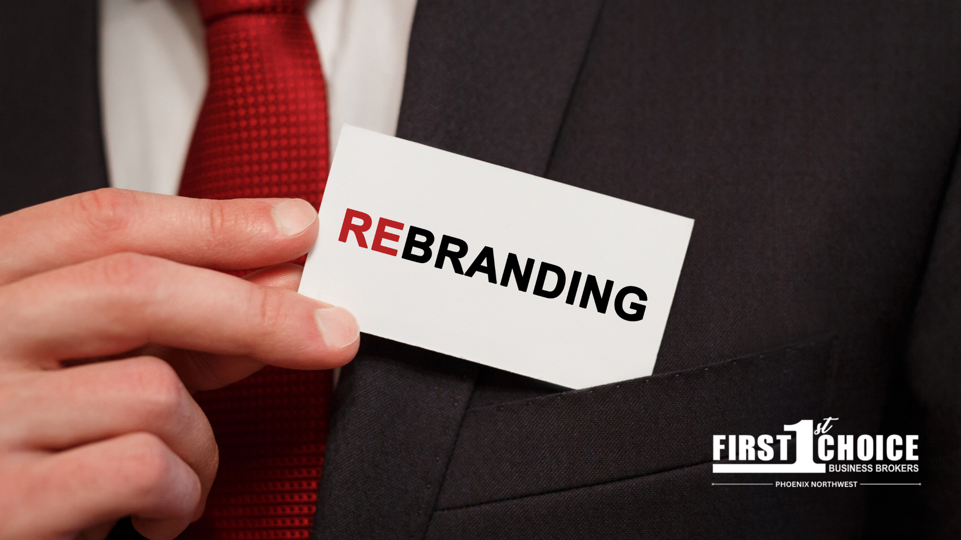 A man in a suit and tie is holding a card that says rebranding