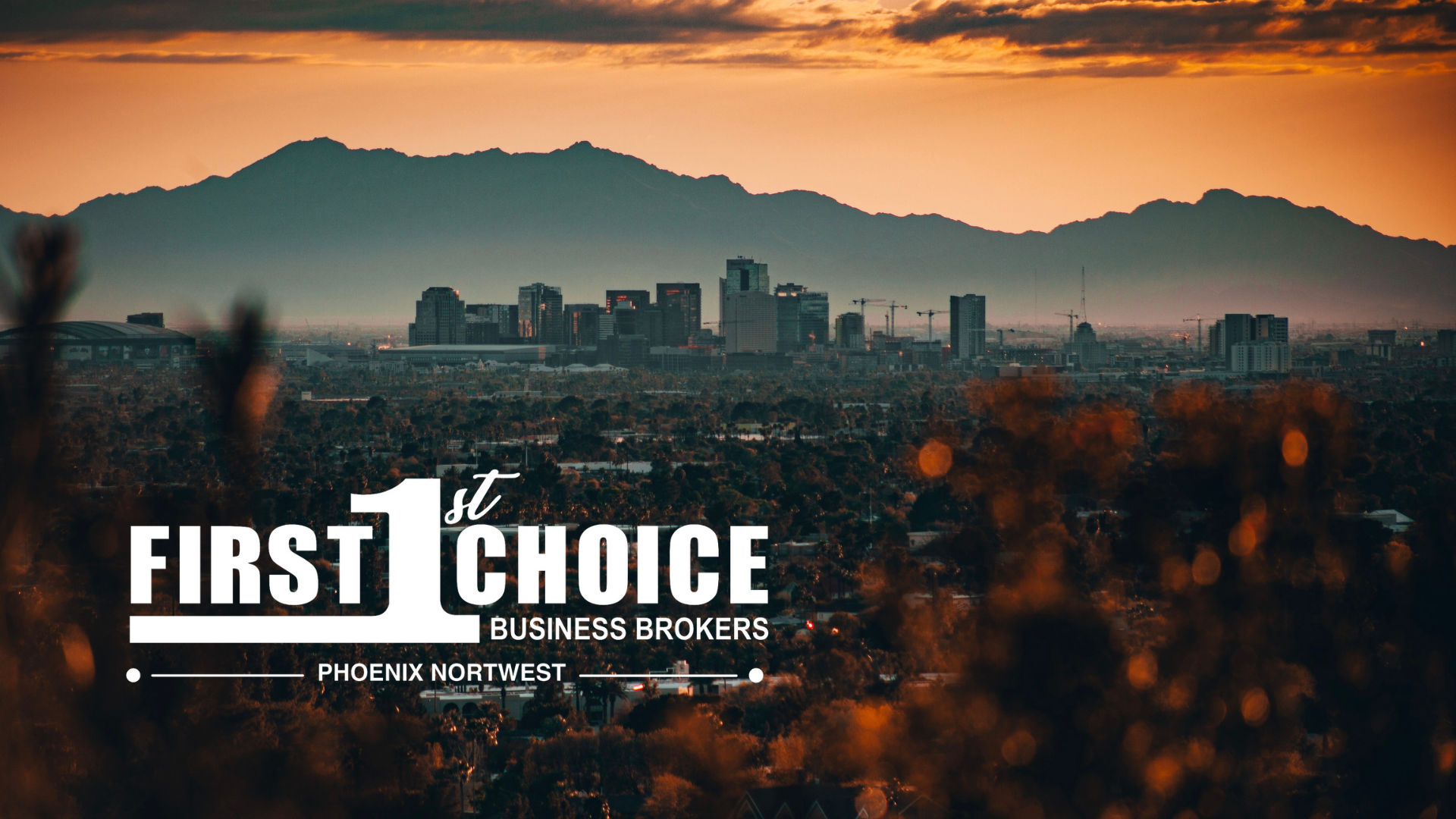 A city skyline with mountains in the background and the words `` first choice '' on the bottom.