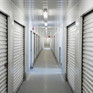 A long hallway filled with rows of white shuttered doors.